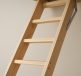 Close-up view of a well-designed wooden loft ladder against a neutral wall